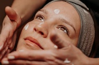 a woman getting a facial treatment at a spa
