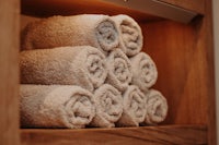 a stack of towels on a wooden shelf