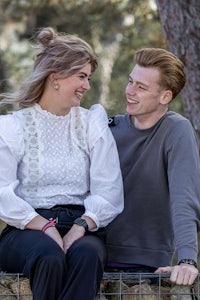 a man and a woman sitting on a bench