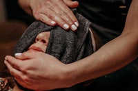 a woman getting a facial treatment at a spa