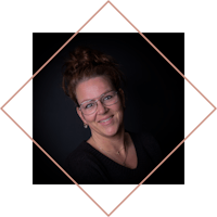 a portrait of a woman with glasses and a black background